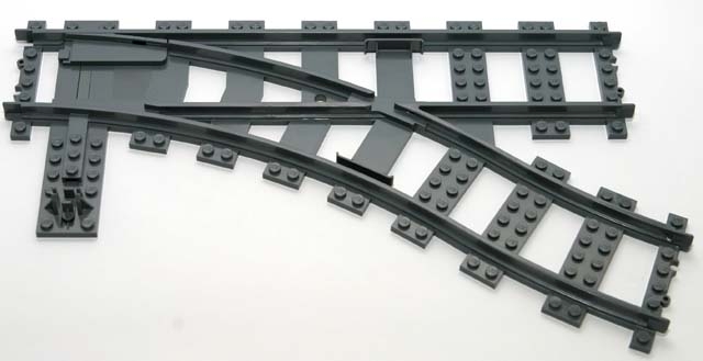 Train, Track Plastic (RC Trains) Switch Point Right
I god stand. Komplett med gul switchbrikke.