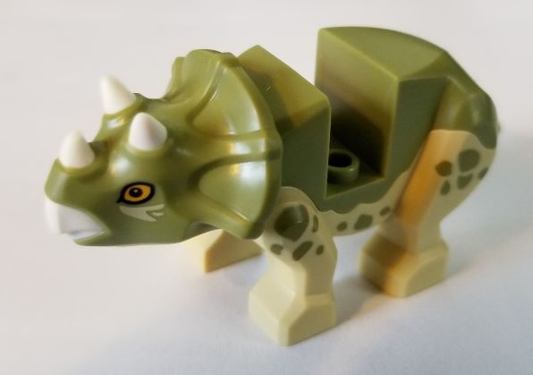Dinosaur Triceratops Baby with Fixed Olive Green Top with Molded White Horns and Beak and Printed Bright Light Orange Eyes and Olive Green Spots Pattern
Komplett i god stand.